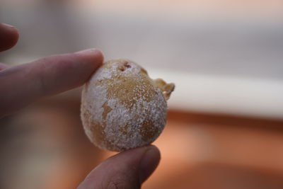 Close-up of hand holding jacket potatoe in sea salt, tenerife