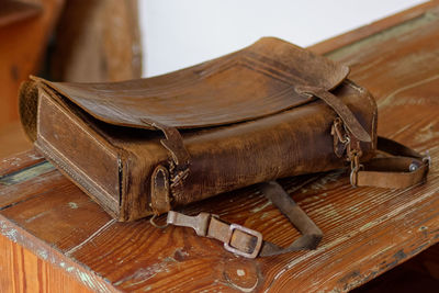 Close-up of old bag on wooden table