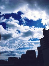 Low angle view of building against cloudy sky