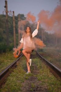 Full length of woman standing on railroad track
