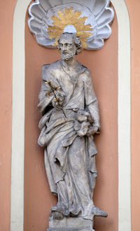 Statue of buddha against wall