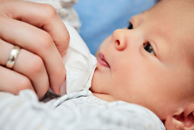 Close-up of baby girl sleeping on bed at home