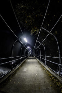 Illuminated bridge at night