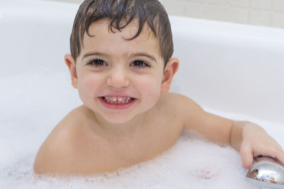 Portrait of smiling boy in bathroom