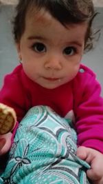 Close-up portrait of smiling girl at home