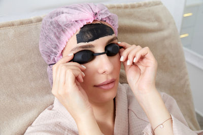Portrait of young woman wearing sunglasses