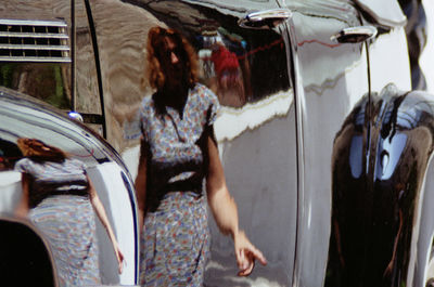Woman standing in car