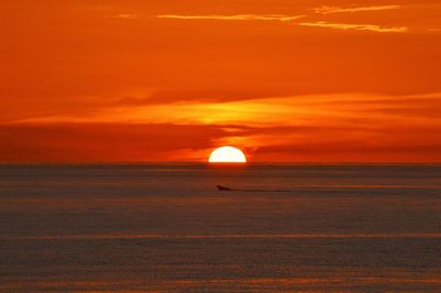 Scenic view of sea against orange sky