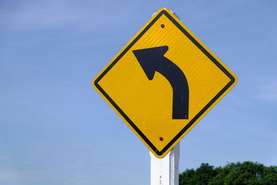 Low angle view of road sign against sky