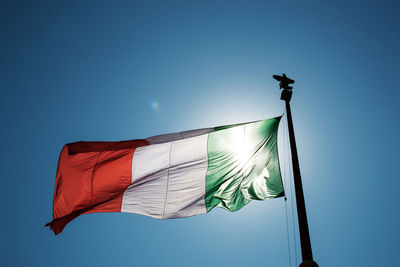 Low angle view of italian flag against clear blue sky