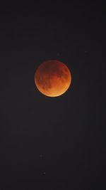 Low angle view of moon against clear sky at night