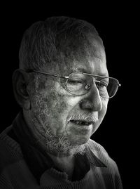 Portrait of man wearing mask against black background