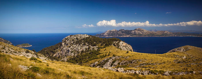 Panoramic view of sea and mountains against sky