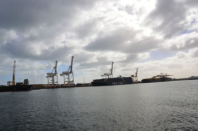 Commercial dock by sea against sky