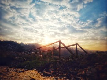 Bridge over land against sky during sunset