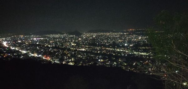 High angle view of illuminated buildings in city at night