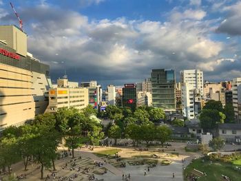 High angle view of trees and buildings against sky