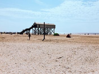 Lifeguard hut on beach against sky