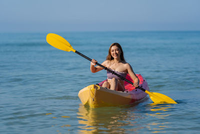 Portrait of woman swimming in sea