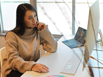 Businesswoman using computer in office