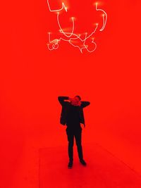 Full length of silhouette man standing against red sky