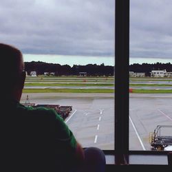 Cropped image of people looking through window