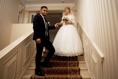 Full length of young woman standing in corridor