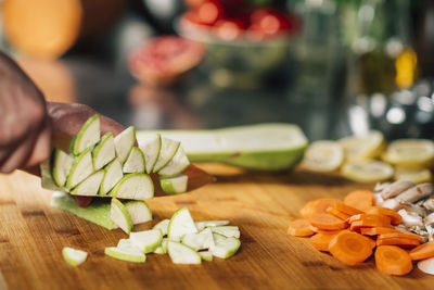 Cutting fresh zucchini - preparing vegan meal