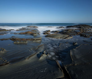 Scenic view of sea against clear blue sky