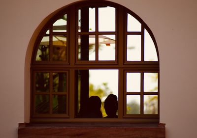 People seen through glass window of building