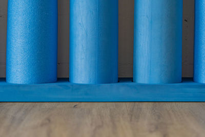 Blue pilates roll with white brick wall. for balance- and stabilisation exercises. close up.