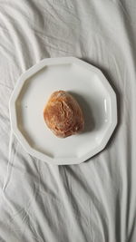 High angle view of bread in plate on bed