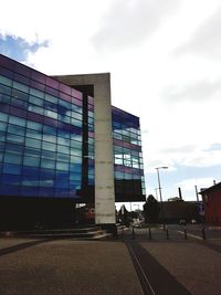 Modern building against cloudy sky