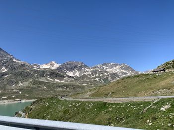 Scenic view of snowcapped mountains against clear blue sky