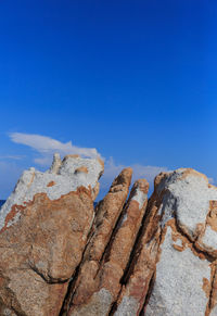 Close-up of rock against blue sky