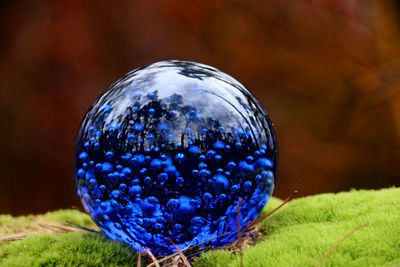 Close-up of blue crystal ball on field