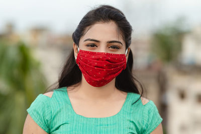 Close-up of woman wearing red mask
