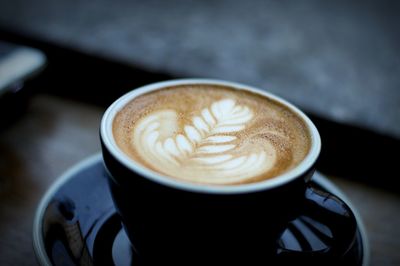 Close-up of cappuccino in cup on table