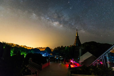 Illuminated buildings against sky at night