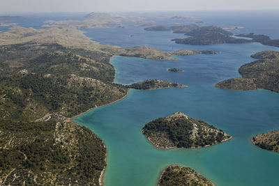 High angle view of rocks in sea against sky