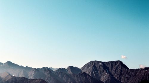 Scenic view of mountains against blue sky