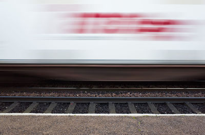 Blurred motion of train at railroad station