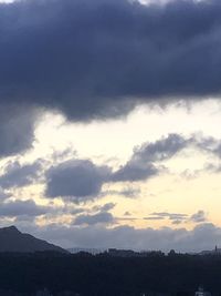 Scenic view of silhouette mountains against sky at sunset