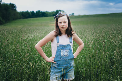 Full length of happy woman standing on field