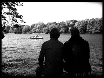 Rear view of man looking at lake