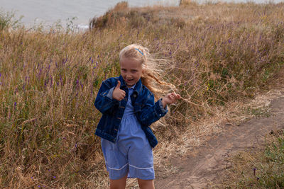 Full length of girl standing on field