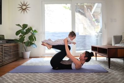Mother with daughter exercising at home