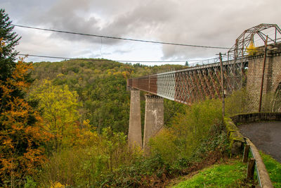 View of bridge and trees against sky