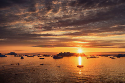 Scenic view of sea against orange sky