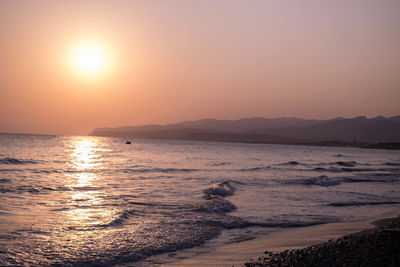 Scenic view of sea against clear sky during sunset